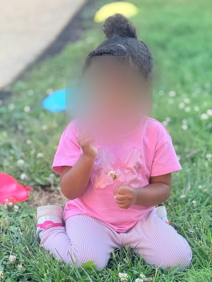 A flower, thoroughly inspected at EduCastle Learning Center, faces blurred for privacy