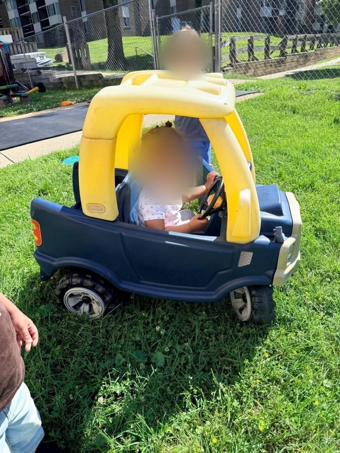 Morning traffic on the lawn at EduCastle Learning Center, faces blurred for privacy