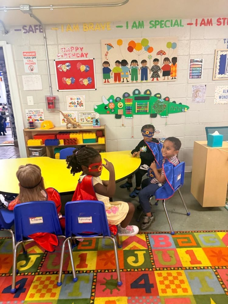 Children in superhero capes and masks at EduCastle