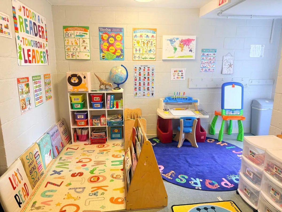 Preschool and Pre-K classroom at EduCastle with a reading corner, book displays, a writing desk and an easel